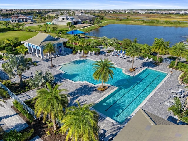 pool with a patio area and a water view