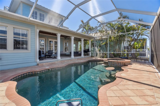 view of swimming pool with a patio area, glass enclosure, a pool with connected hot tub, and ceiling fan