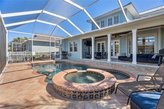 view of swimming pool featuring an outdoor living space, french doors, a pool with connected hot tub, and a patio