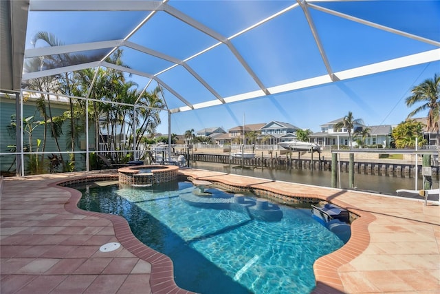 view of swimming pool featuring glass enclosure, a patio area, a water view, and a pool with connected hot tub