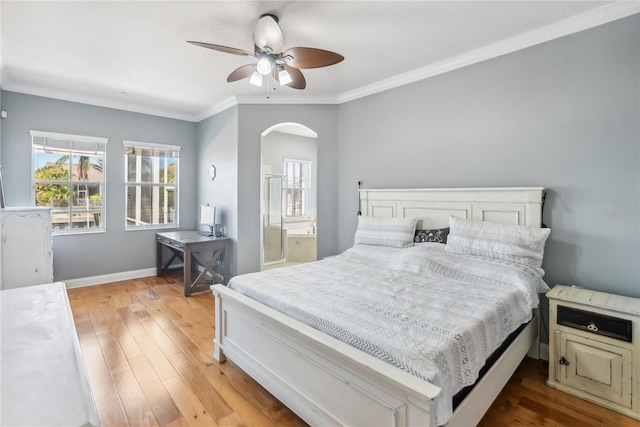 bedroom with baseboards, arched walkways, ceiling fan, ornamental molding, and light wood-style floors