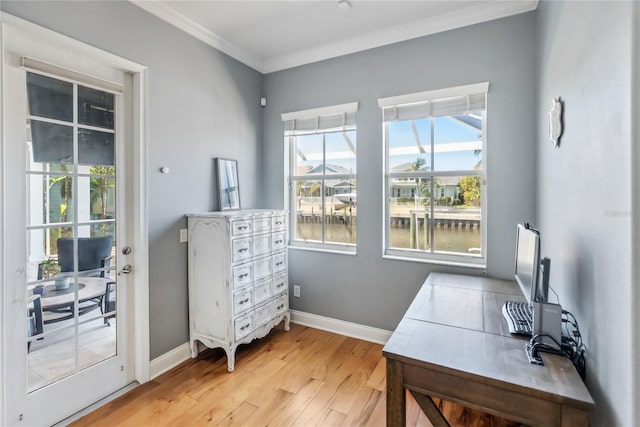 office area with light wood-type flooring, baseboards, and ornamental molding