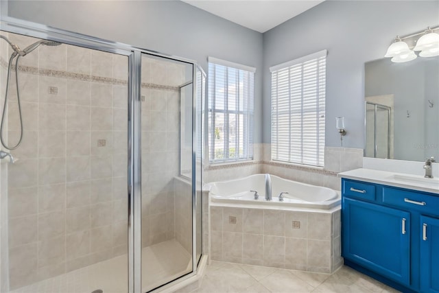 full bathroom with a bath, tile patterned flooring, a stall shower, and vanity