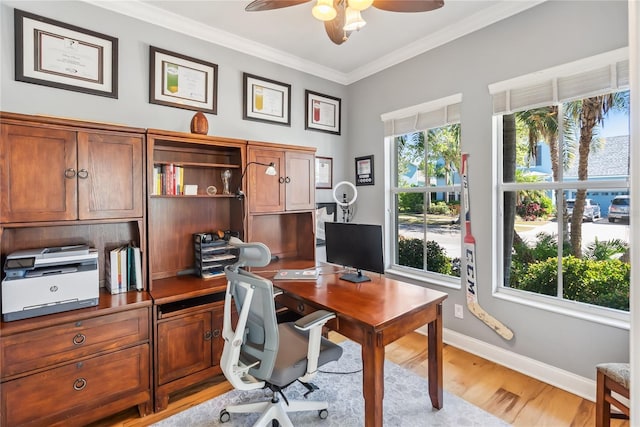 office area with crown molding, baseboards, light wood-type flooring, and ceiling fan