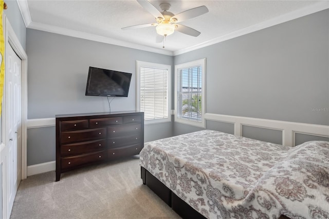 bedroom featuring crown molding, a ceiling fan, and carpet floors