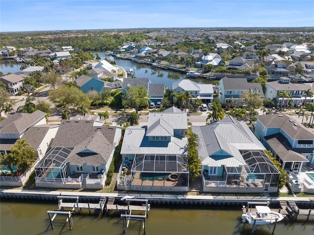 drone / aerial view with a residential view and a water view