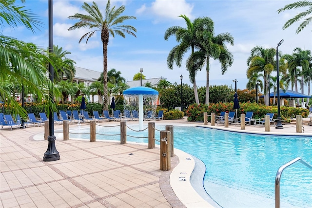 pool with a patio and fence