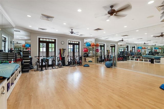 workout area featuring visible vents, a ceiling fan, and wood finished floors