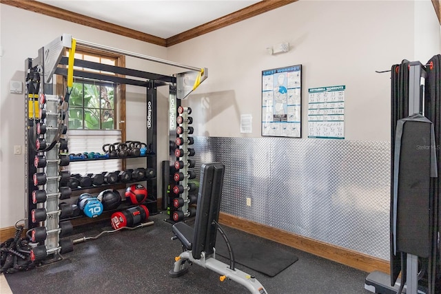 exercise area featuring crown molding