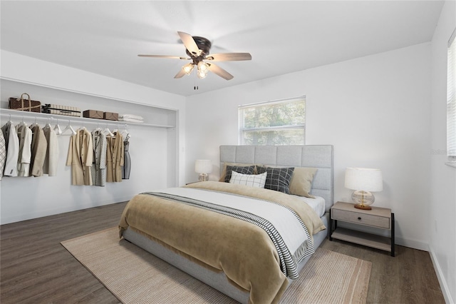 bedroom with baseboards, a closet, a ceiling fan, and wood finished floors