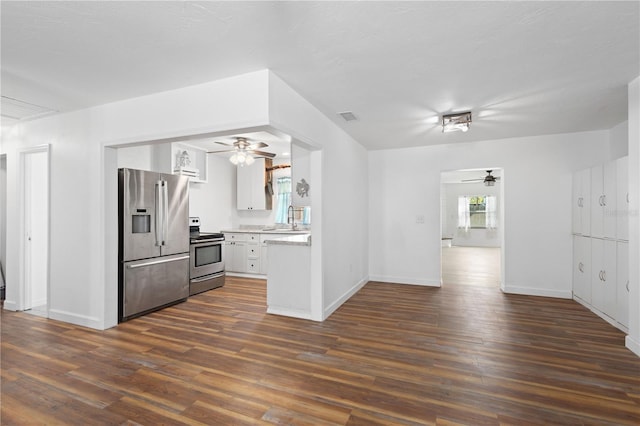 kitchen with dark wood-type flooring, visible vents, stainless steel appliances, and light countertops