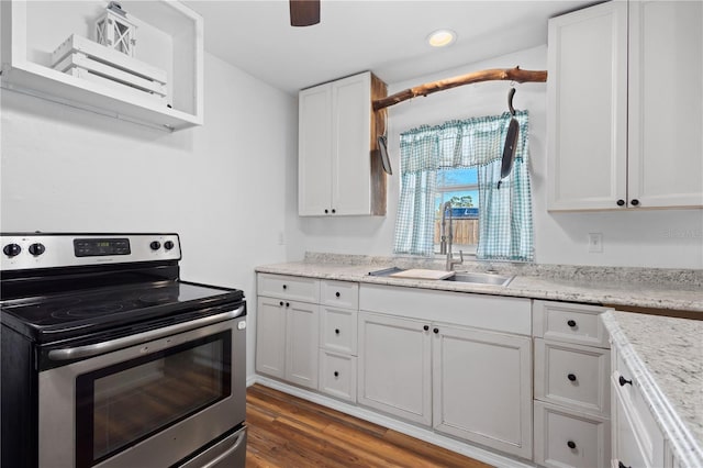 kitchen featuring white cabinets, dark wood-style flooring, stainless steel electric stove, a sink, and recessed lighting