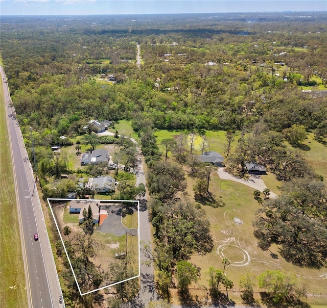 birds eye view of property with a view of trees