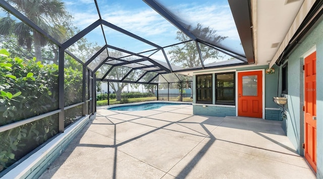 pool with glass enclosure and a patio area