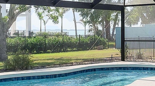 view of pool featuring a fenced in pool, glass enclosure, a yard, and fence