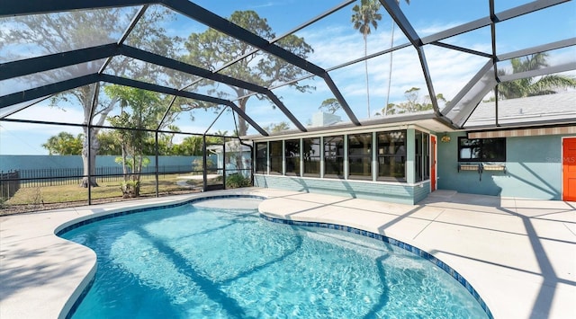 view of pool with a fenced in pool, glass enclosure, fence, and a patio