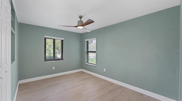 unfurnished room with light wood-style floors, a ceiling fan, and baseboards