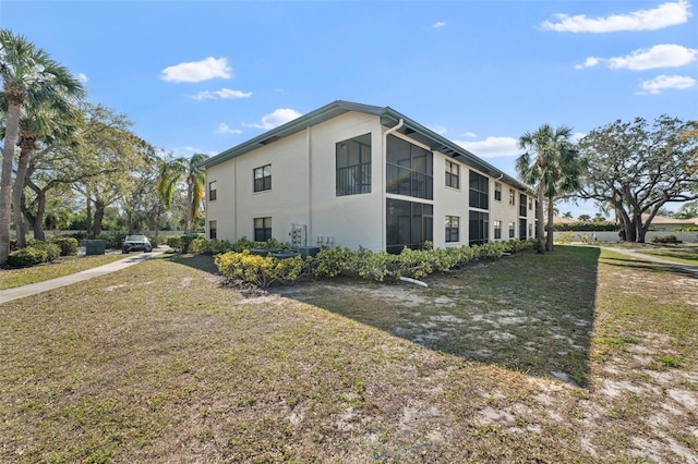 view of side of home with a lawn