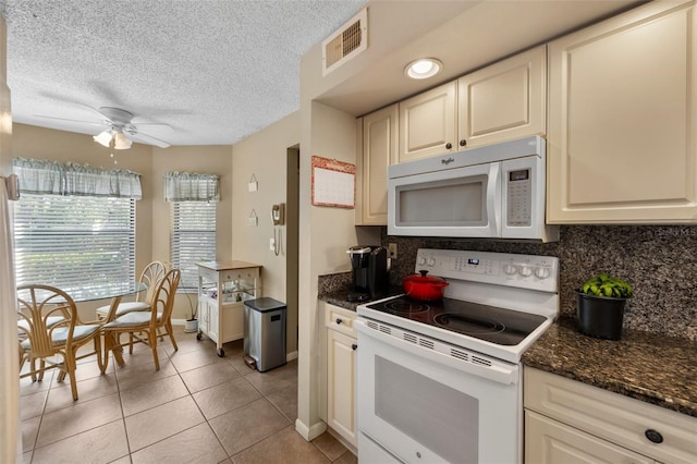 kitchen featuring white appliances, ceiling fan, visible vents, and backsplash