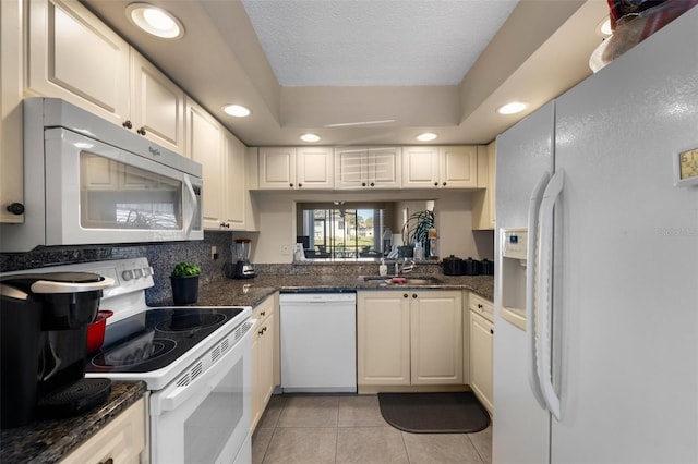 kitchen with a textured ceiling, light tile patterned flooring, recessed lighting, white appliances, and tasteful backsplash