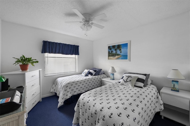 bedroom with a textured ceiling, dark colored carpet, and ceiling fan