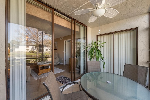 sunroom with a ceiling fan