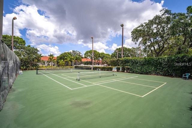 view of tennis court with fence