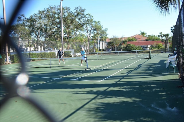 view of sport court with fence