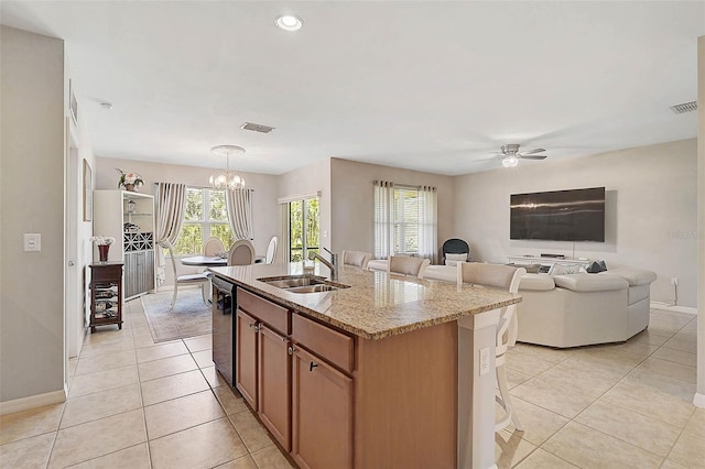 kitchen with a breakfast bar area, a sink, and visible vents