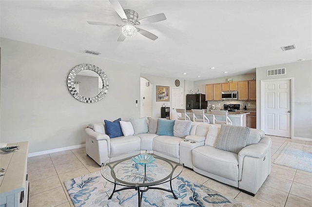 living area featuring visible vents, baseboards, and light tile patterned floors