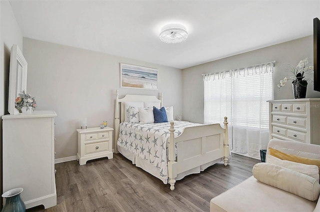 bedroom featuring dark wood-style floors and baseboards