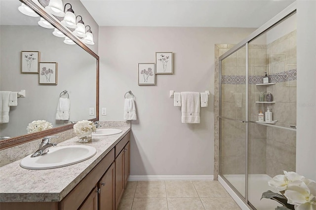 full bathroom with tile patterned flooring, a sink, and a shower stall