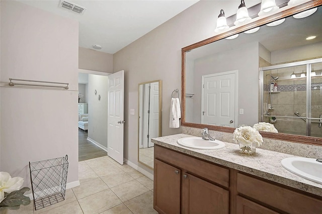 full bathroom with a sink, visible vents, tile patterned floors, double vanity, and a stall shower