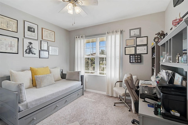 office space with light carpet, baseboards, and a ceiling fan