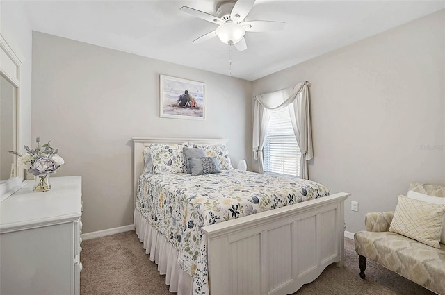 bedroom featuring a ceiling fan, light colored carpet, and baseboards