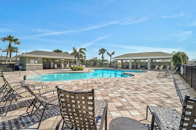 community pool featuring a patio area and fence