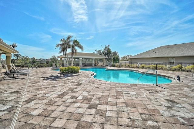 pool with fence and a patio