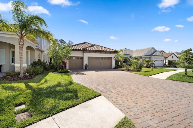 view of front facade featuring decorative driveway, stucco siding, an attached garage, a front yard, and a residential view