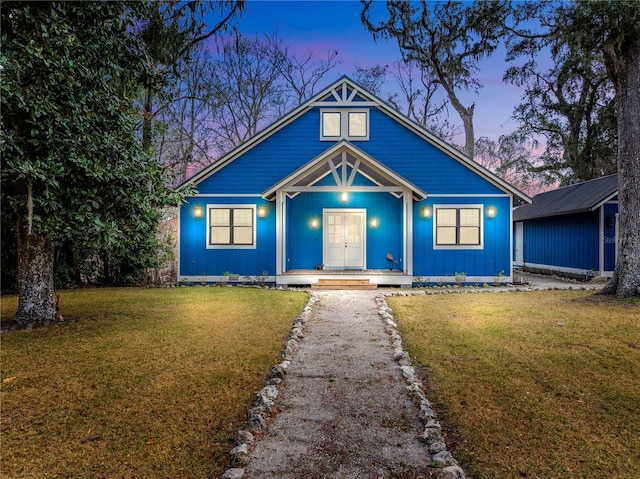 view of front of house with french doors and a front yard