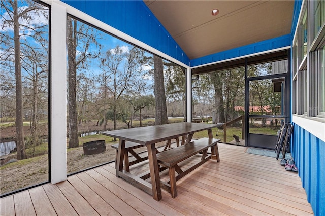 sunroom featuring vaulted ceiling