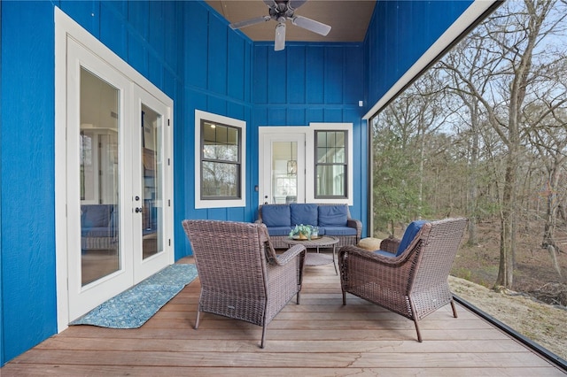 wooden deck with a ceiling fan, french doors, and an outdoor living space