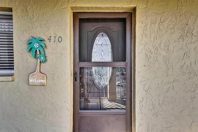 property entrance with stucco siding