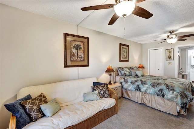 bedroom featuring carpet, a ceiling fan, and a textured ceiling