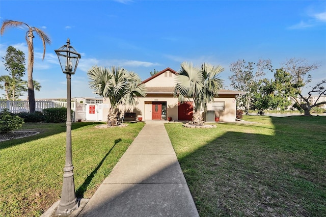 view of front of house featuring a front lawn and stucco siding