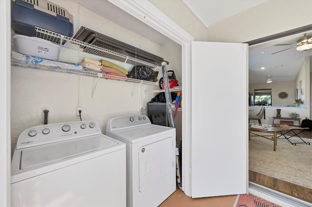 laundry room featuring a ceiling fan, laundry area, light wood-style flooring, and separate washer and dryer