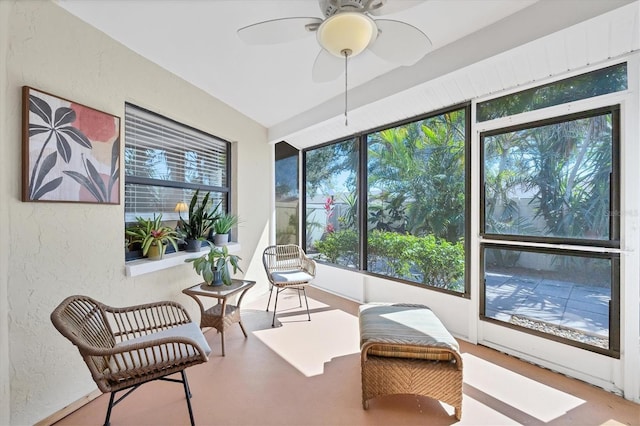 sunroom / solarium featuring a ceiling fan