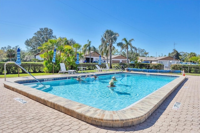 pool with fence and a patio