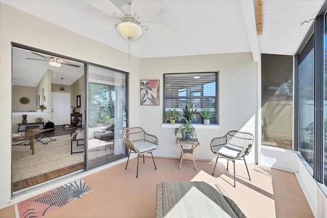 sunroom featuring ceiling fan