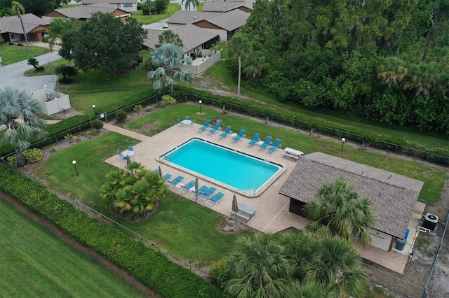 community pool featuring cooling unit and fence