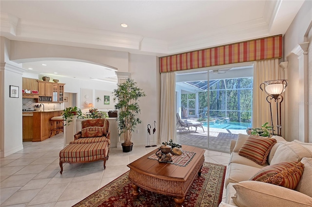 living room with light tile patterned floors, recessed lighting, a sunroom, and ornamental molding